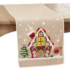 a table runner with a gingerbread house on it