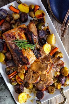 a white plate topped with meat and veggies