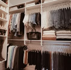 an organized closet with clothes and handbags