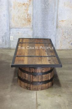 the crate people logo is displayed on top of a wooden barrel that has been turned into a coffee table