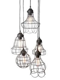 three light fixtures hanging from the ceiling with caged wire and bulbs attached to them