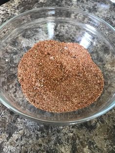 a glass bowl filled with spices on top of a granite counter