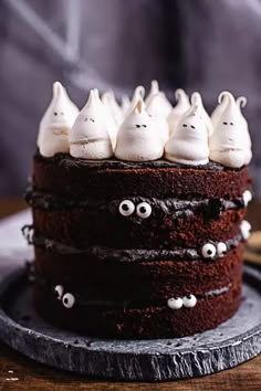 a chocolate cake topped with white frosting and spooky eyes