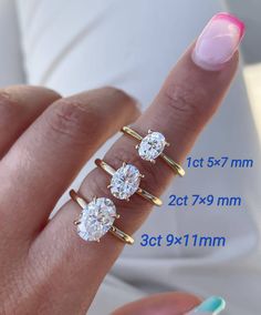 three diamond rings on the finger of a woman's hand with measurements for each ring