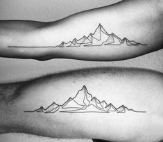 two arm tattoos with mountains on them