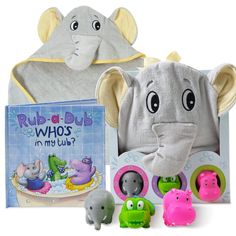 an elephant stuffed animal next to two books and toy animals in front of it's packaging