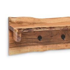 a wooden shelf with three holes in the middle and two black knobs on each side