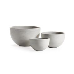 three white bowls sitting next to each other