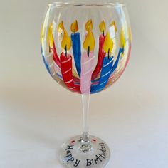 a wine glass with candles painted on it