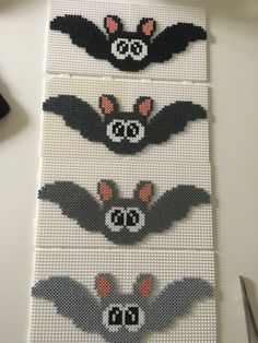 three bat designs made out of perler beads