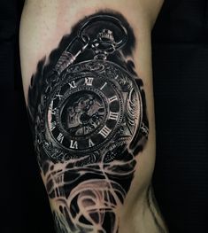 a man's arm with a black and white clock tattoo design on the leg