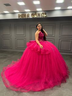 a woman in a pink dress posing for the camera