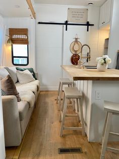 a living room and kitchen area in a tiny home