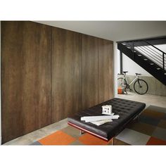 a room with a bench, bike and stairs