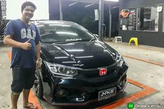 a man standing next to a black car