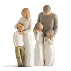 three ceramic figurines of people holding each other's hands and standing next to each other