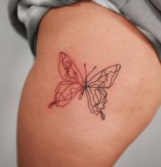 a woman's thigh with a tattoo of a butterfly on it, which is red and black