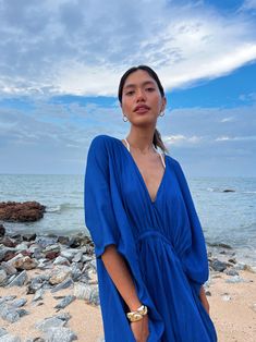 Vacation Wear Edit Blue Breezy Flowy Cover-up, Blue Flowy Breezy Cover-up, Chic Blue Beach Dress For Poolside, Blue Flowy Cover-up For Beach Season, Elegant Blue Dress For Beach Party, Elegant Blue Summer Beach Dress, Chic Blue V-neck Cover-up, Blue Bohemian Resort Cover-up, Blue V-neck Maxi Dress For Poolside