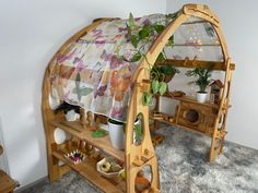 a bed frame with plants and potted plants on it in the corner of a room