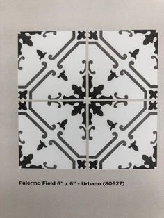 the pattern is made up of black and white tiles with an intricate design on it