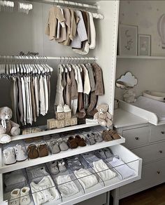 a baby's closet filled with lots of clothes and shoes for babies to wear