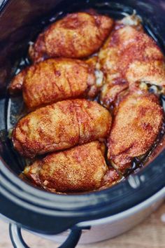 some chicken is cooking in the crock pot and it looks like they have been cooked