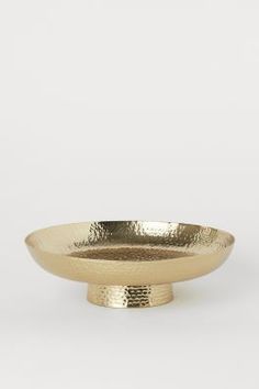 a gold plate sitting on top of a white table