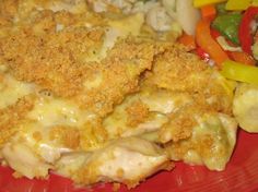 a red plate topped with chicken and veggies