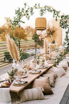 an outdoor table set up with plates and place settings