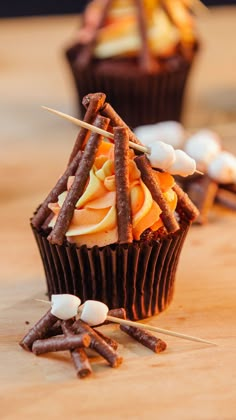 several cupcakes with sticks sticking out of them