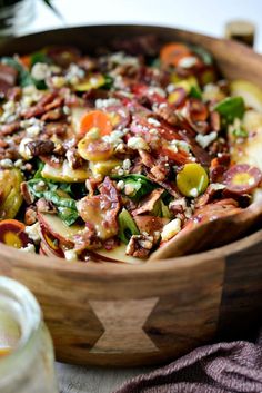 a wooden bowl filled with food on top of a table