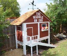 a small red and white chicken coop with the words the weddle on it's roof