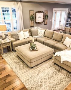 a living room filled with furniture and a large rug on top of a hard wood floor