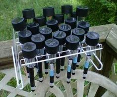 a bunch of black and blue tubes sitting on top of a metal rack next to a wooden bench