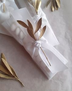 a white box with some gold leaves on it