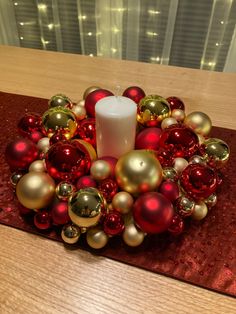 a candle sits in the center of ornaments on a table