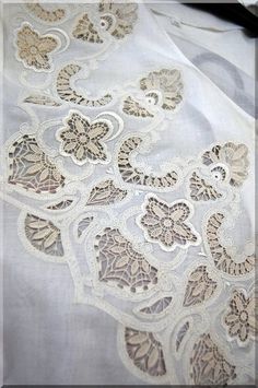 an image of a white cloth with lace on it's edges and flowers in the middle