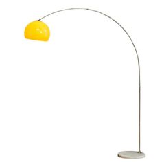 a floor lamp with a yellow shade on it's side and a white base