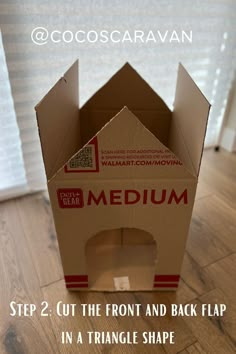 an open cardboard box sitting on top of a wooden floor with the words medium cut the front and back flap in a triangle shape