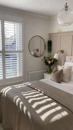 a bed sitting next to a window in a bedroom