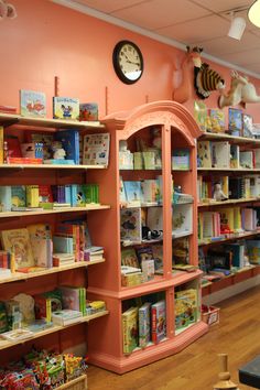 the children's bookshelves are lined up against the wall in the store