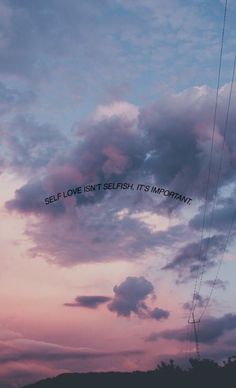 the sky is pink and blue with some writing on it that says self love isn't selfish, its my heart