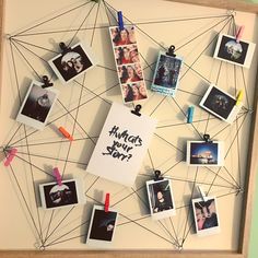 a group of photos hanging on a wall with magnets attached to it and pinned to strings