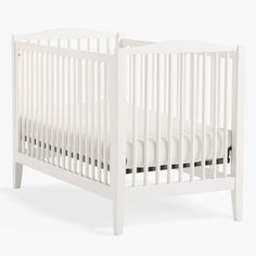 a white crib with no mattress in the middle and black trim on the bottom