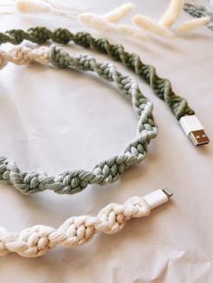 two cables connected to each other on top of a white sheet with crochet