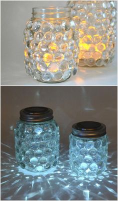 three jars with lights in them sitting next to each other