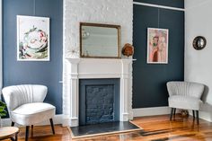 a living room filled with furniture and a fire place in front of a painting on the wall