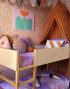 a child's bedroom with two bunk beds and a canopy over the top bed