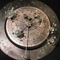 a metal clock with water drops on it