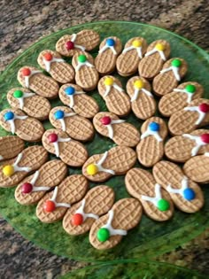 a green plate topped with cookies covered in white icing